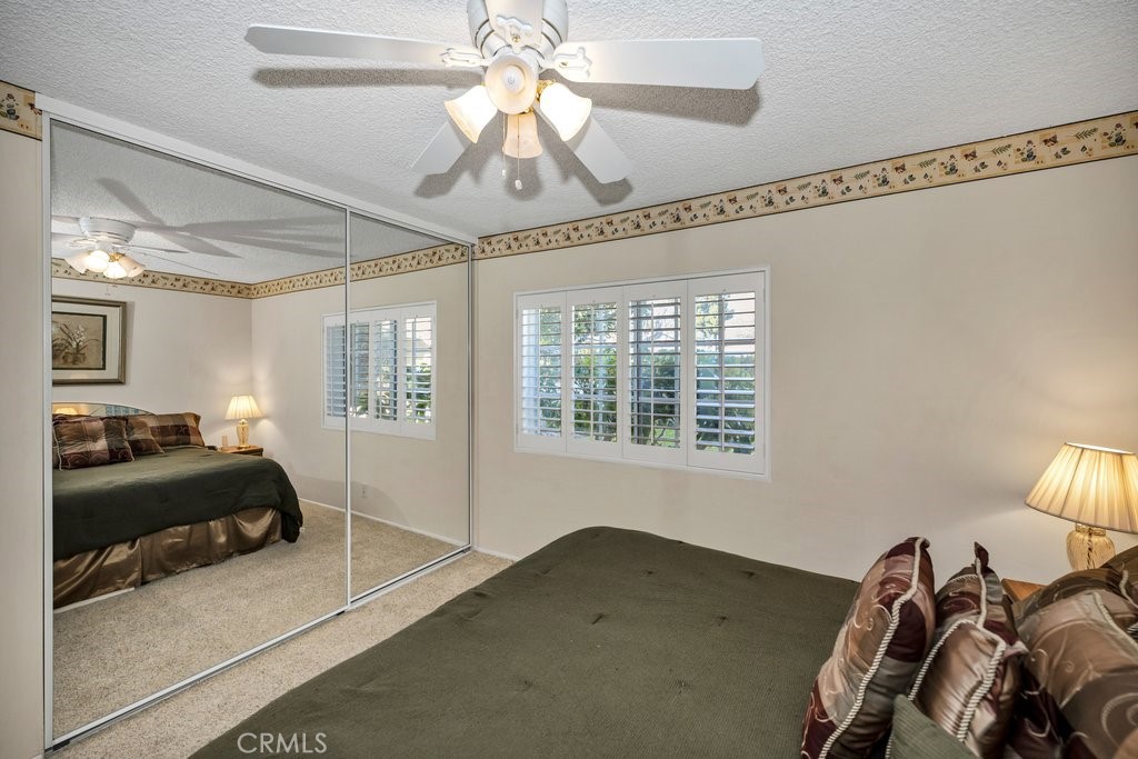 9916 Bothwell Road Northridge, CA 91324 - Photo 30 of 41 a bedroom with a bed and a chandelier