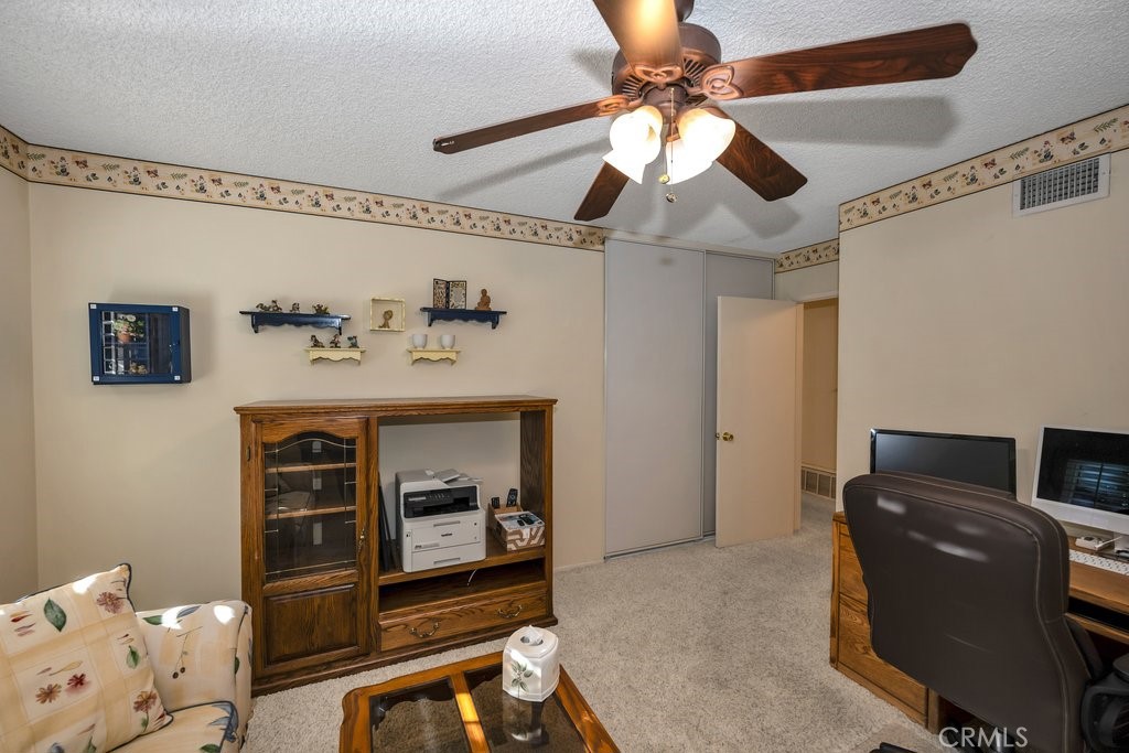 9916 Bothwell Road Northridge, CA 91324 - Photo 32 of 41 a living room with furniture and a flat screen tv