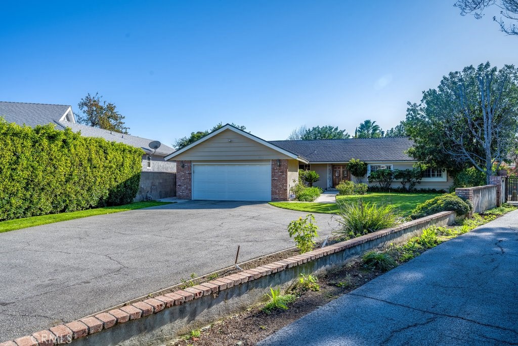 9916 Bothwell Road Northridge, CA 91324 - Photo 4 of 41 a front view of a house with a yard and potted plants