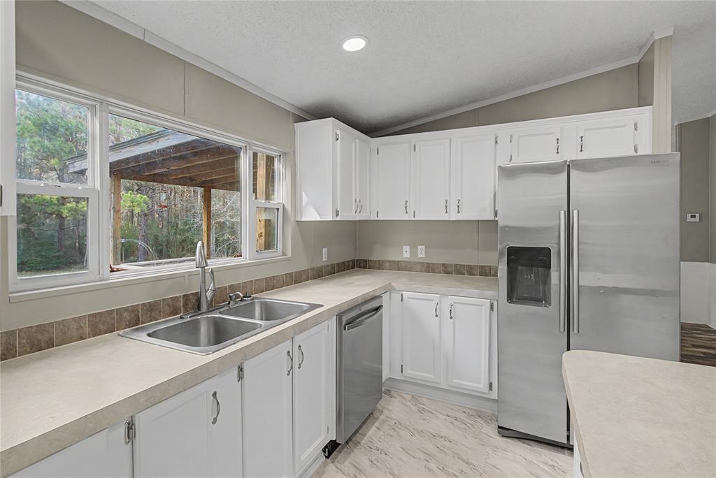 428 Cash Blackmon Road Logansport, LA 71049 - Photo 15 of 40 a kitchen that has a sink cabinets counter space and appliances