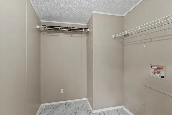 a view of an empty room with a ceiling fan