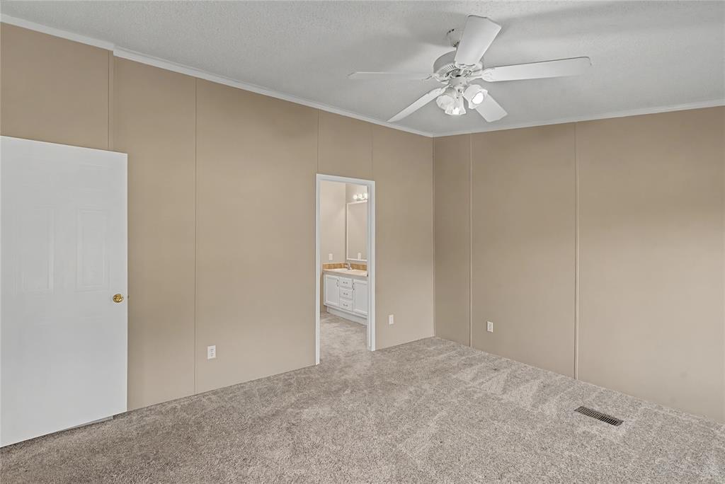 428 Cash Blackmon Road Logansport, LA 71049 - Photo 18 of 40 a view of an empty room with a ceiling fan