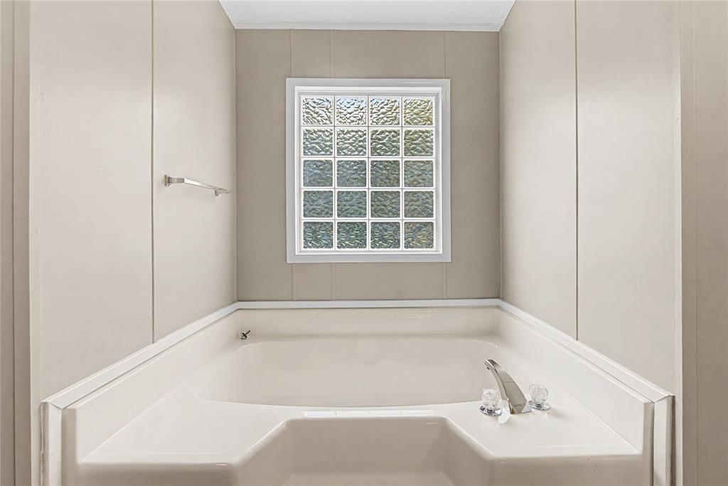 428 Cash Blackmon Road Logansport, LA 71049 - Photo 20 of 40 a white bath tub sitting next to a white sink