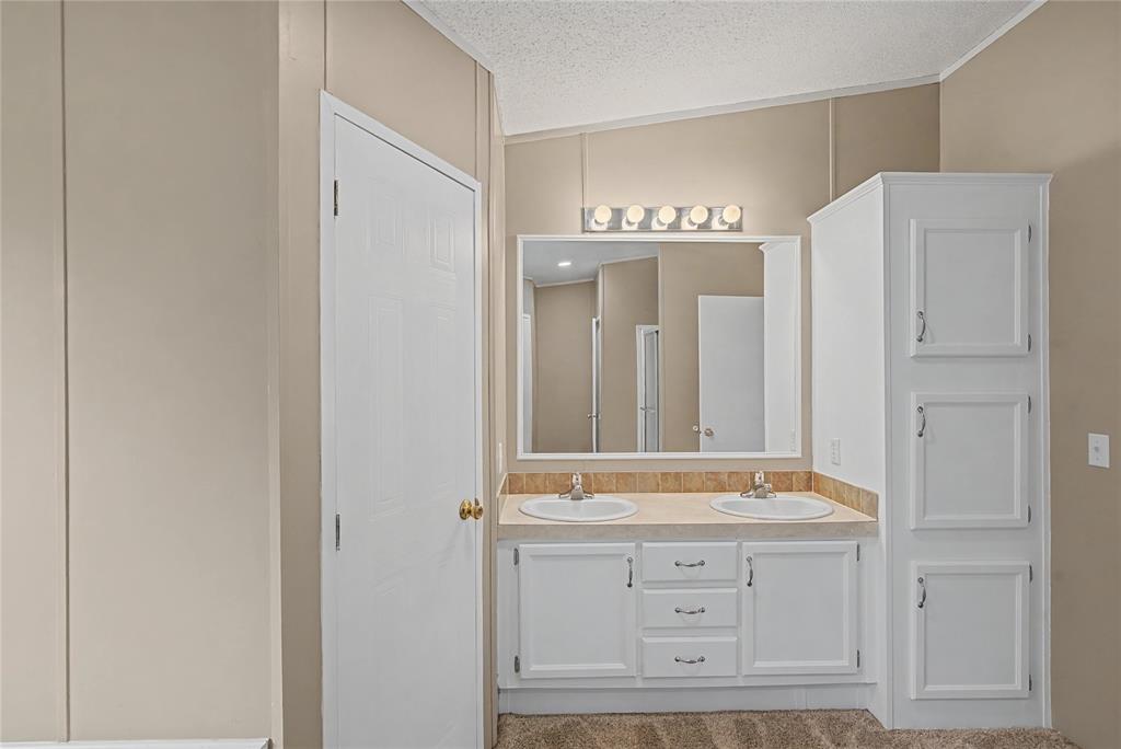 428 Cash Blackmon Road Logansport, LA 71049 - Photo 21 of 40 a bathroom with a granite countertop sink and a mirror