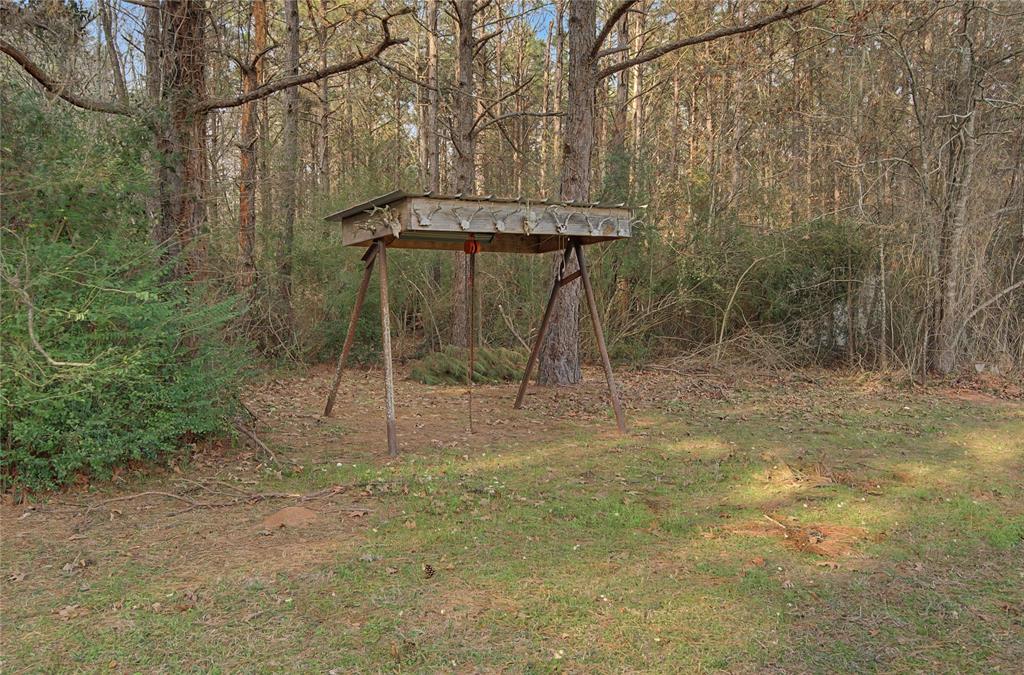 428 Cash Blackmon Road Logansport, LA 71049 - Photo 37 of 40 a backyard of a house with table and chairs