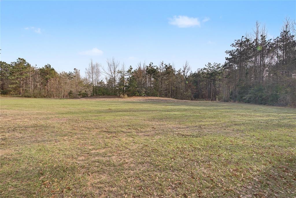428 Cash Blackmon Road Logansport, LA 71049 - Photo 39 of 40 a view of a field with trees in the background