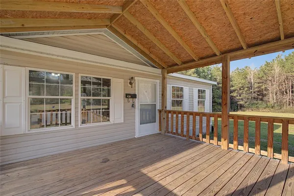 a view of empty room with wooden floor and fireplace