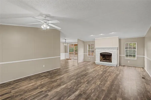 a view of an empty room with a fireplace and a window