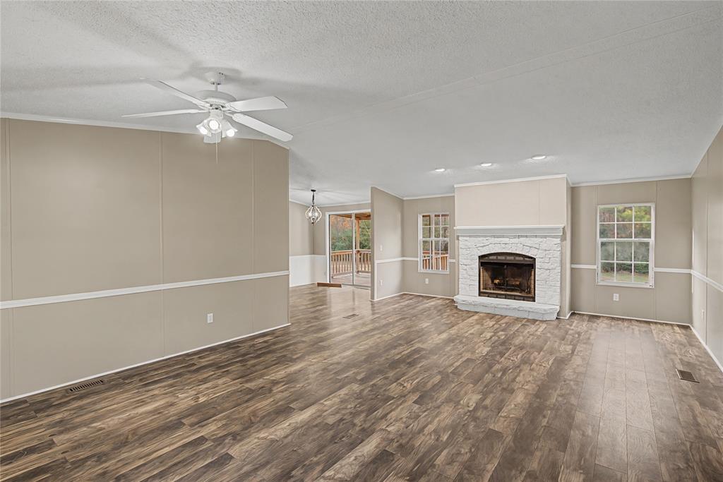 428 Cash Blackmon Road Logansport, LA 71049 - Photo 6 of 40 a view of empty room with wooden floor and fireplace