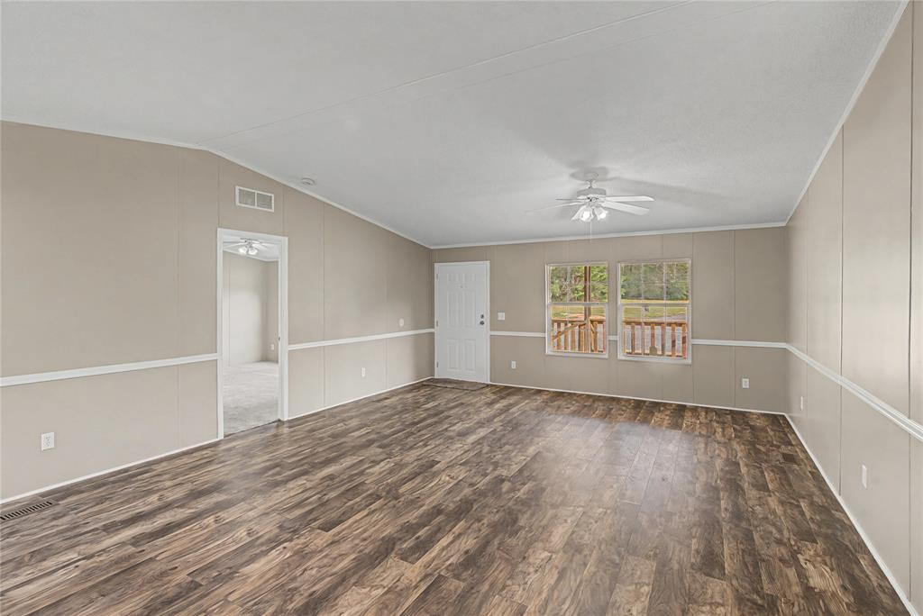428 Cash Blackmon Road Logansport, LA 71049 - Photo 9 of 40 wooden floor in an empty room with a window