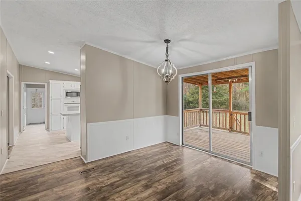 a kitchen with granite countertop white cabinets white stainless steel appliances with a sink and dishwasher