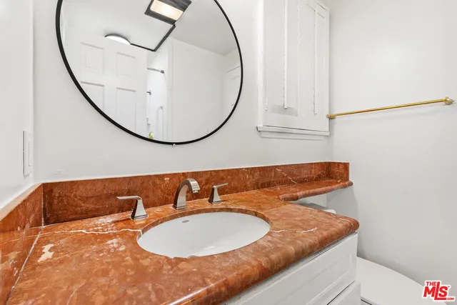 a bathroom with a sink and a mirror