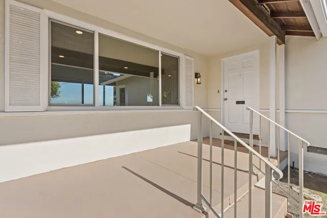 a view of staircase with white walls and windows