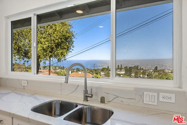 a kitchen with a sink and a large window