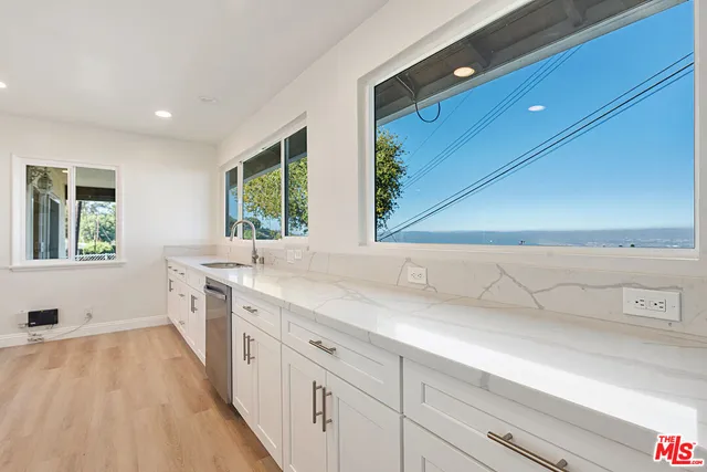 a bathroom with a sink a large mirror and a bathtub