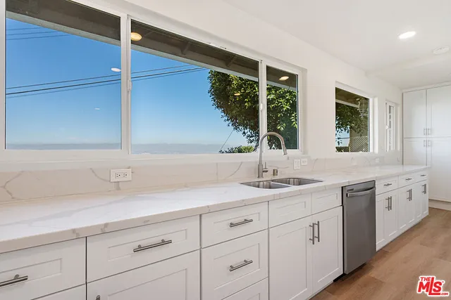 a bathroom with a sink and a window
