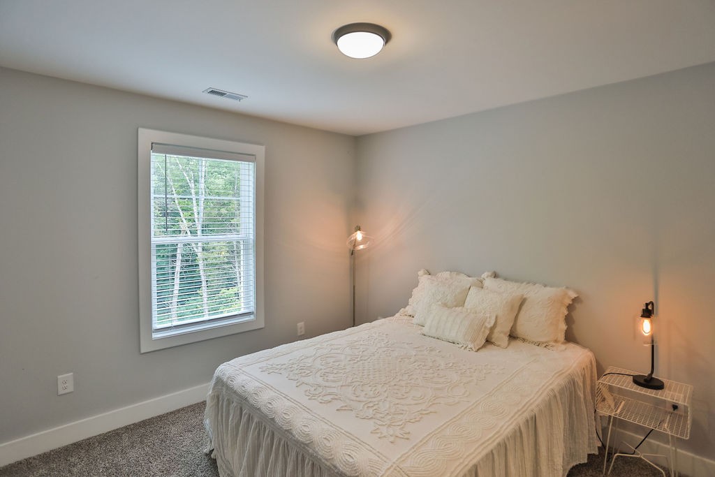 13 Sycamore Ridge West Burns, TN 37029 - Photo 17 of 24 a bedroom with a bed and with windows