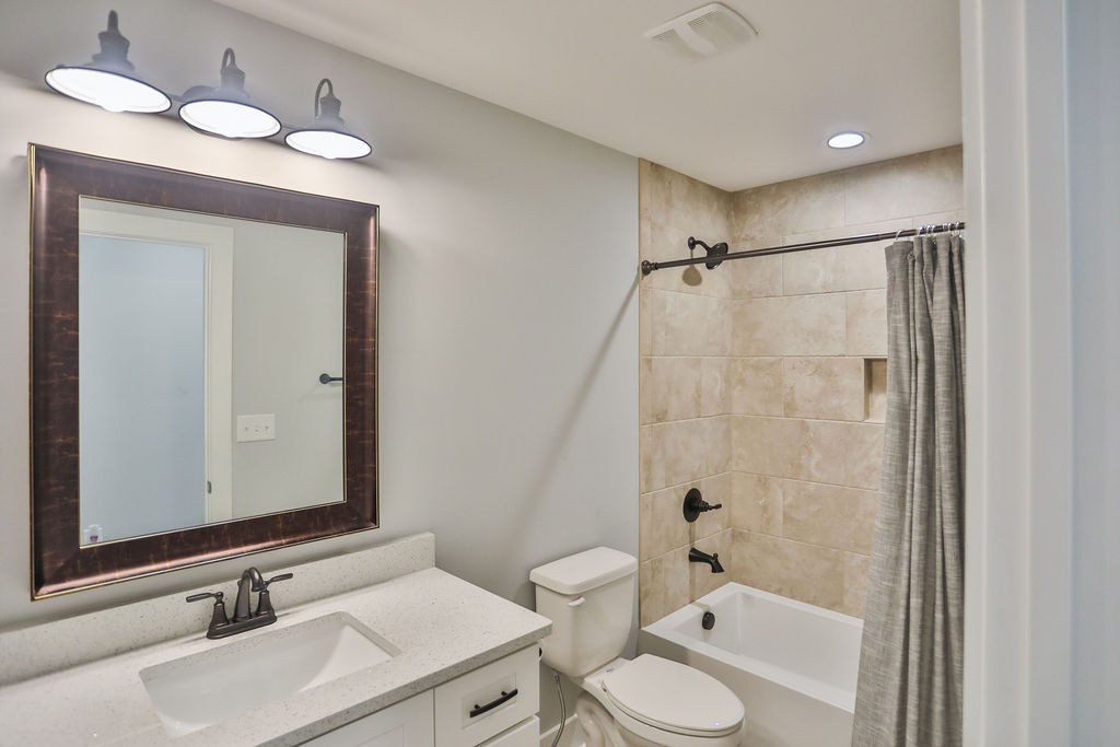 13 Sycamore Ridge West Burns, TN 37029 - Photo 19 of 24 a bathroom with a granite countertop sink toilet a mirror and shower