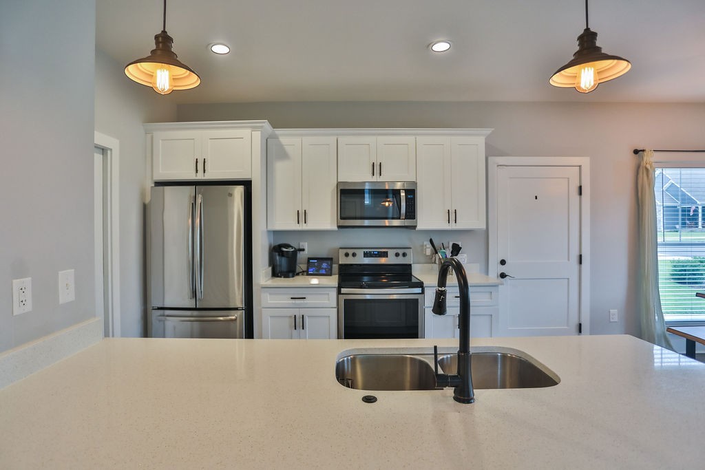 13 Sycamore Ridge West Burns, TN 37029 - Photo 8 of 24 a kitchen with stainless steel appliances granite countertop a refrigerator a stove a sink and a granite counter tops