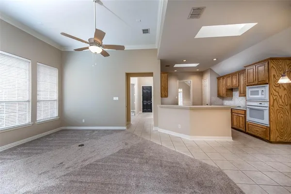 a view of a kitchen with refrigerator and a kitchen