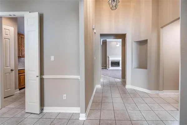 a view of a hallway with closet and a window