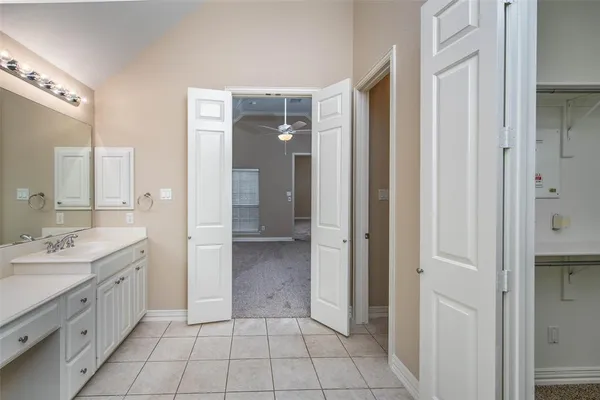 a spacious bathroom with a double vanity sink a mirror and a shower