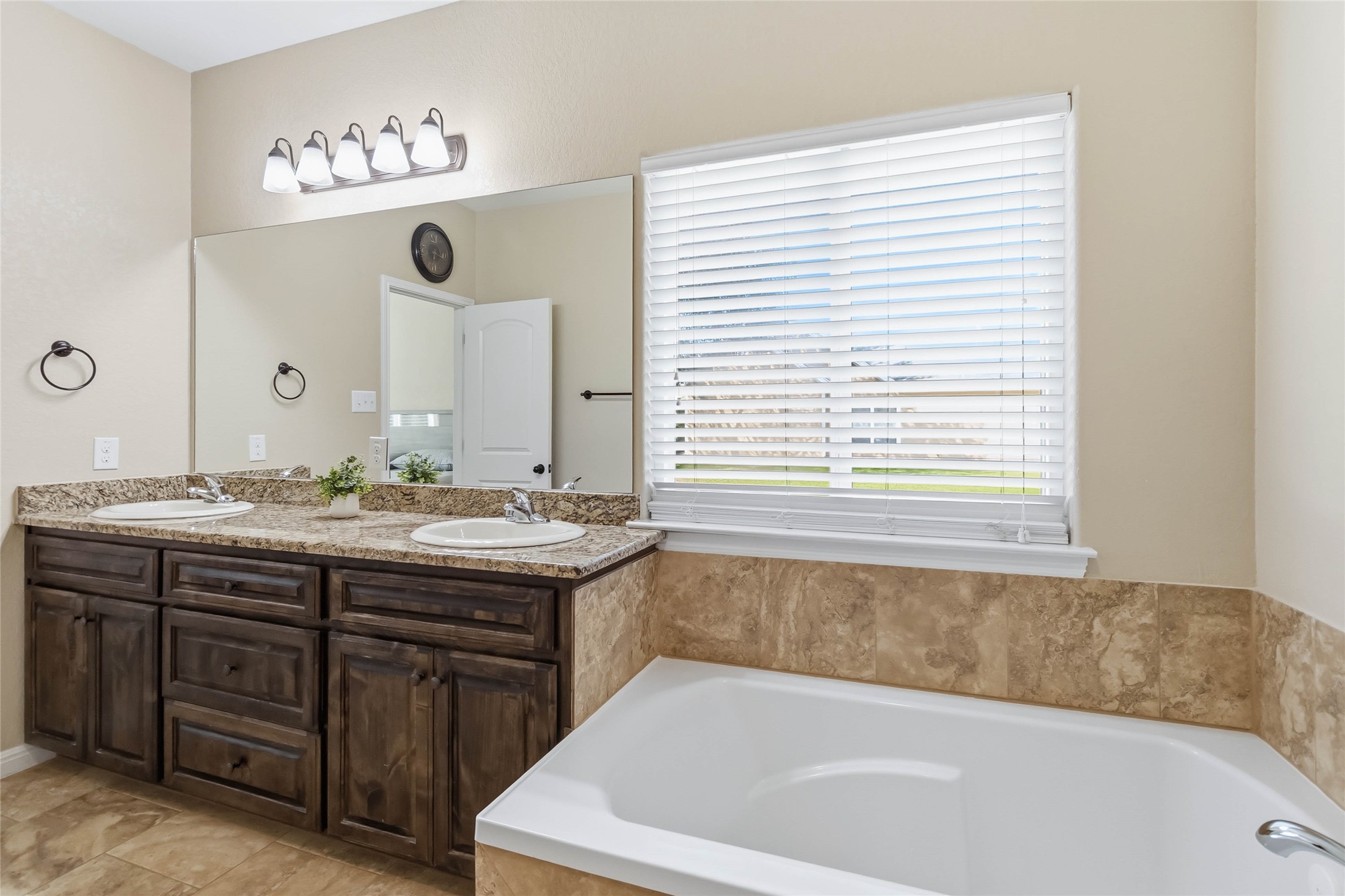 285 Hummingbird Way Martindale, TX 78655 - Photo 22 of 40 a bathroom with a granite countertop sink and a bathtub