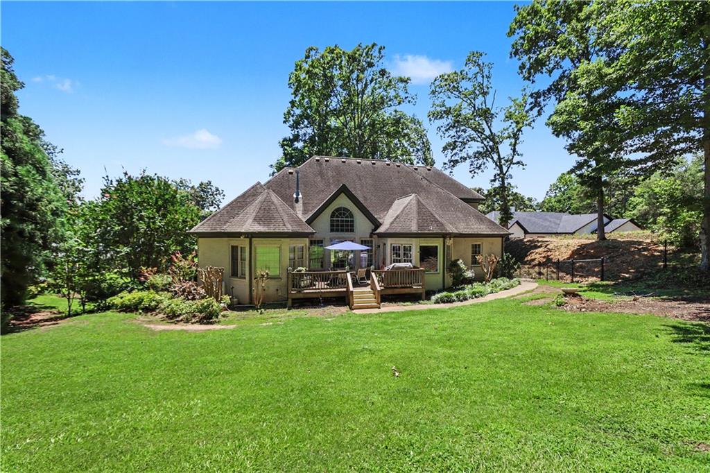537 Old Collins Road Hoschton, GA 30548 - Photo 37 of 42 a view of a house with backyard garden and sitting area
