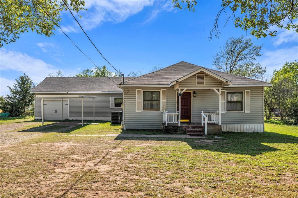 a front view of a house with a yard outdoor seating and yard