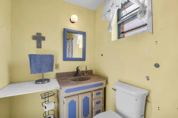 a bathroom with a sink a toilet and mirror