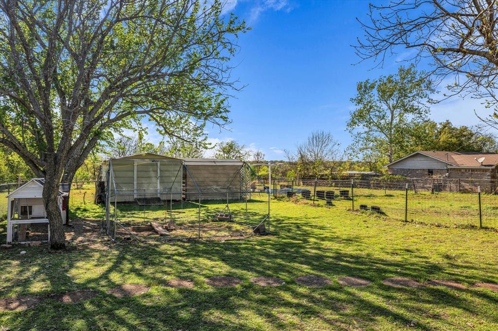 982 North Houston Street Lorena, TX 76655 - Photo 25 of 35 a swimming pool with outdoor seating and yard
