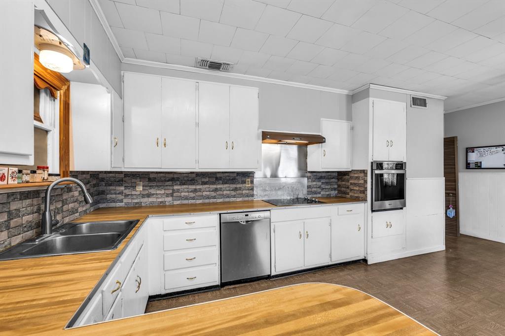 982 North Houston Street Lorena, TX 76655 - Photo 28 of 35 a kitchen with granite countertop a sink and cabinets