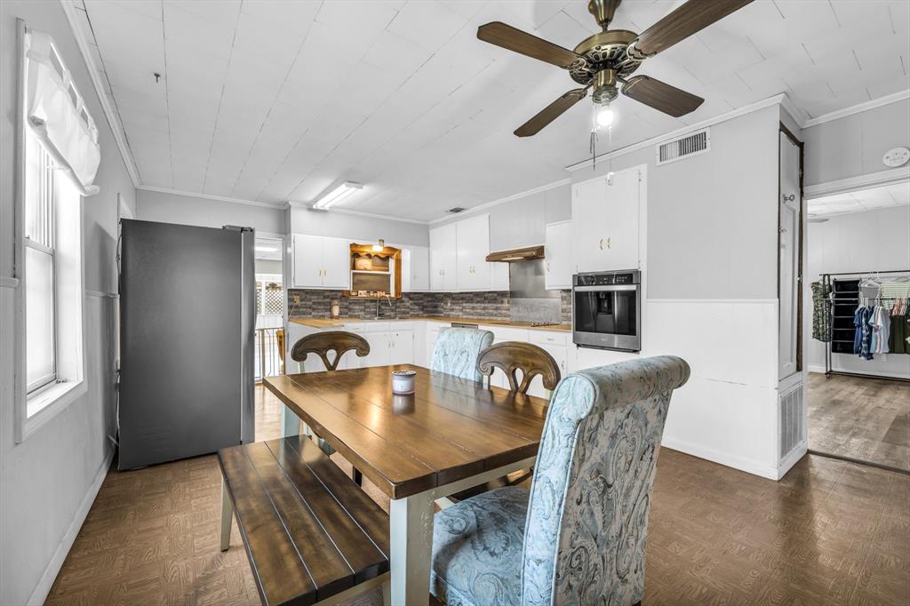 982 North Houston Street Lorena, TX 76655 - Photo 29 of 35 a kitchen with kitchen island stainless steel appliances a table chairs and a refrigerator