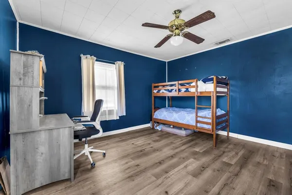 a bedroom with furniture and a window