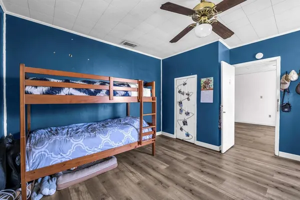 a bedroom with a bed and a chandelier