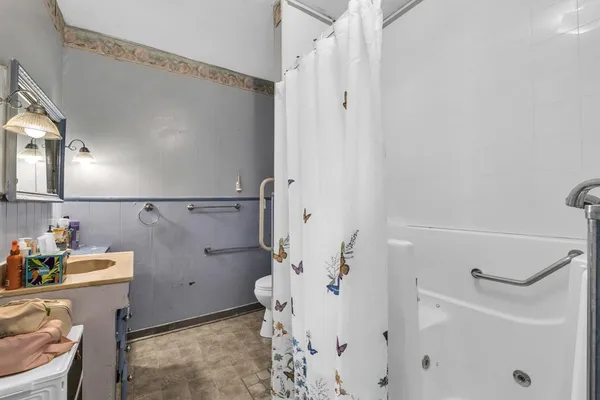 a bathroom with a sink toilet and shower