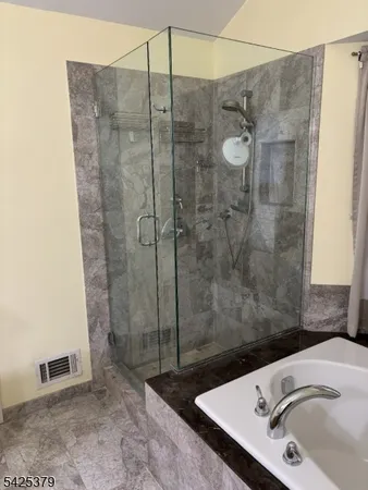 a bathroom with a sink and shower