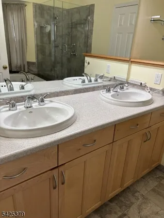 a bathroom with double sink and a mirror