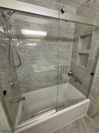 a bath tub sitting next to a shower