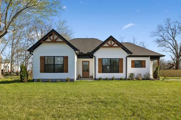 a front view of house with yard and green space