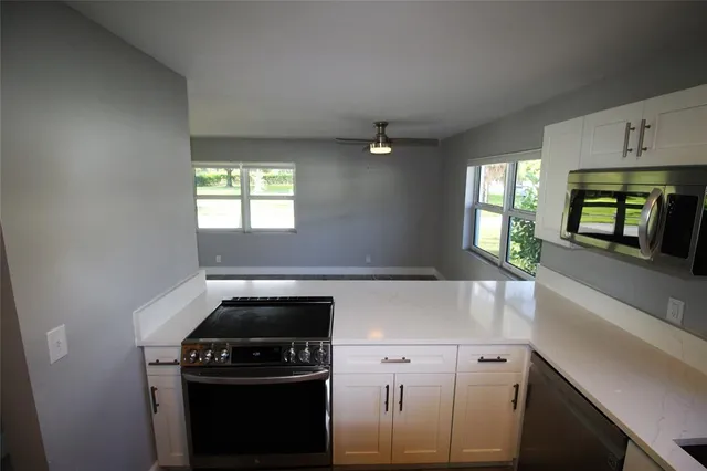a kitchen with granite countertop a stove and a sink