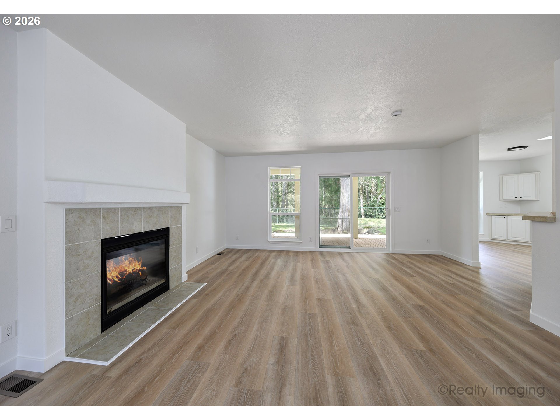 68908 East Cedar Hill Loop Welches, OR 97067 - Photo 6 of 21 a view of an empty room with wooden floor fireplace and a window
