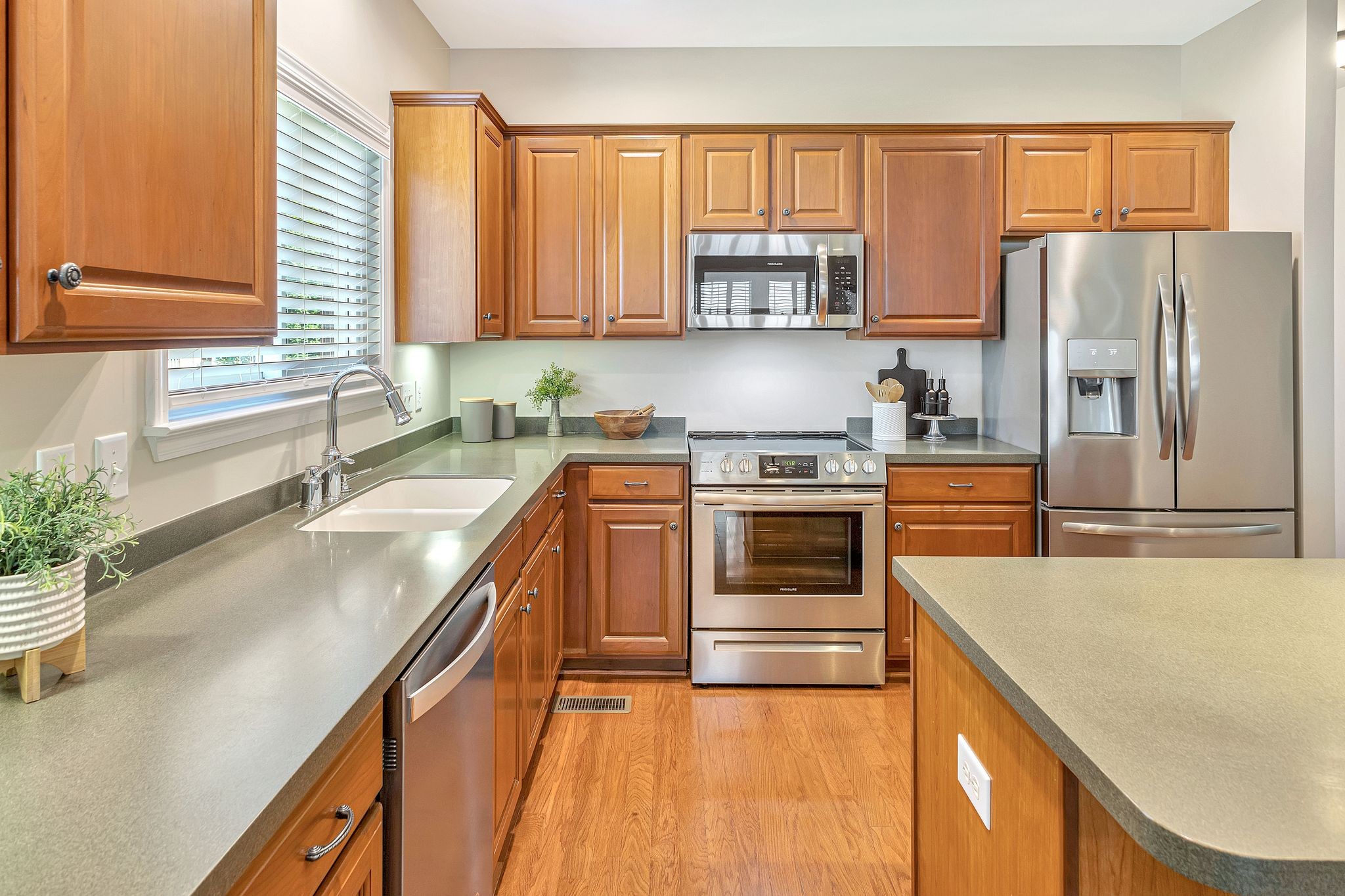 1311 Decatur Circle Franklin, TN 37067 - Photo 13 of 38 a kitchen with stainless steel appliances a stove a sink and a refrigerator