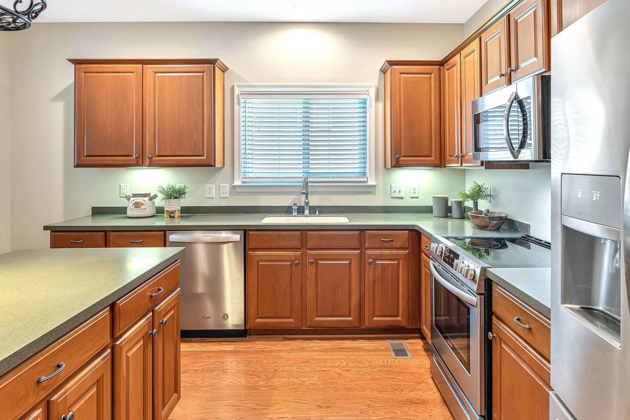 1311 Decatur Circle Franklin, TN 37067 - Photo 14 of 38 a kitchen with stainless steel appliances granite countertop a sink stove and cabinets