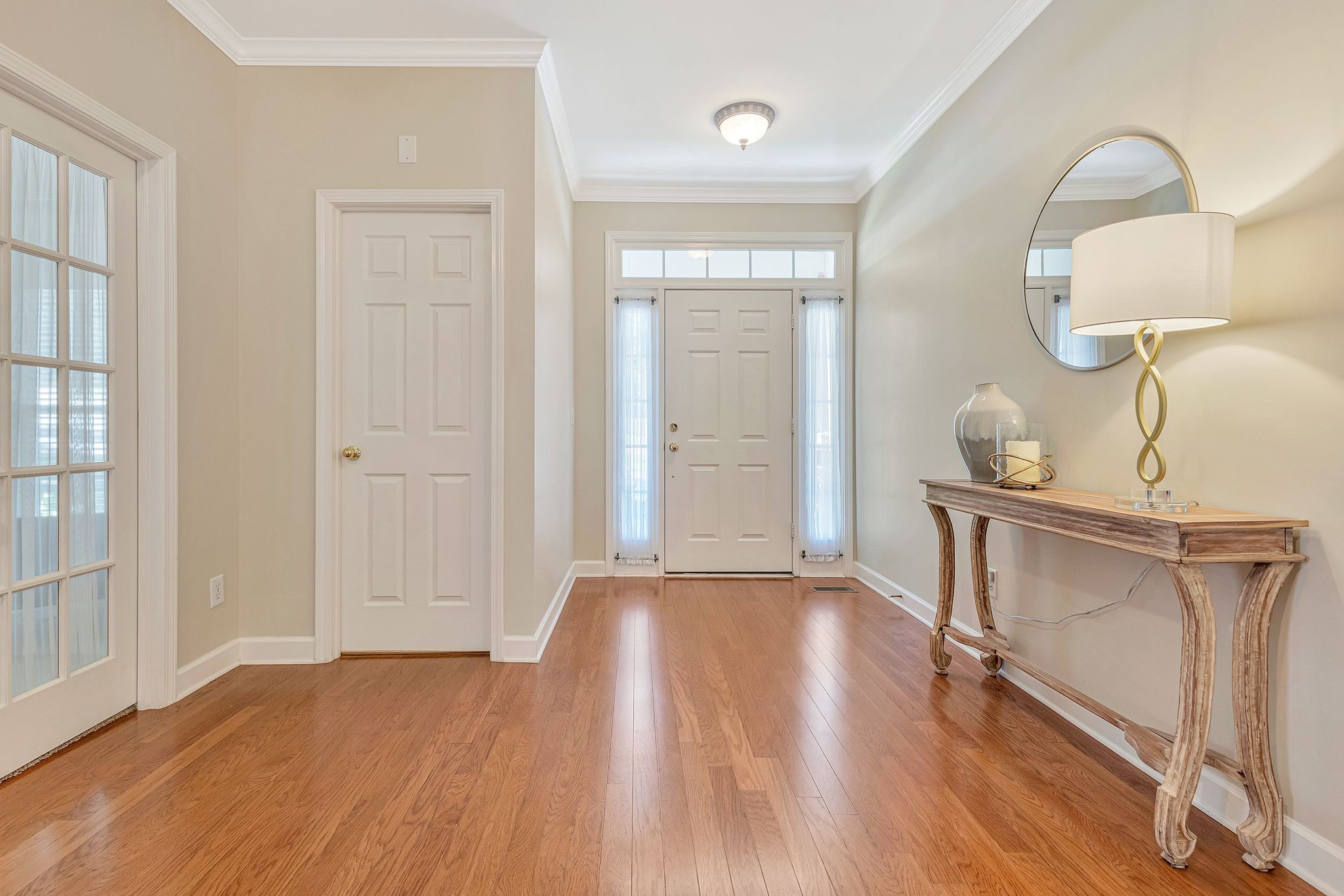1311 Decatur Circle Franklin, TN 37067 - Photo 7 of 38 a view of an empty room with wooden floor and a mirror