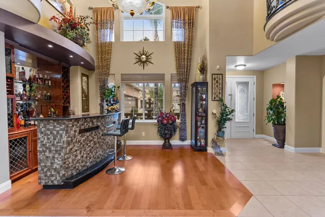 a living room with furniture a floor to ceiling window and potted plant