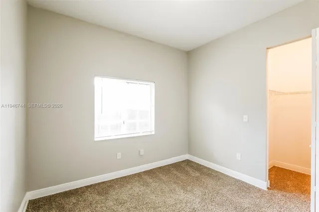 a view of a room with wooden floor and closet