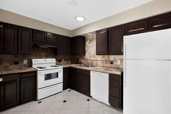 a kitchen with a sink and a refrigerator