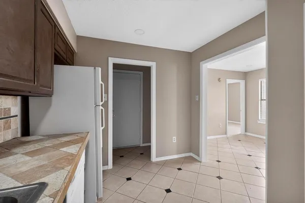a view of a kitchen with white cabinets