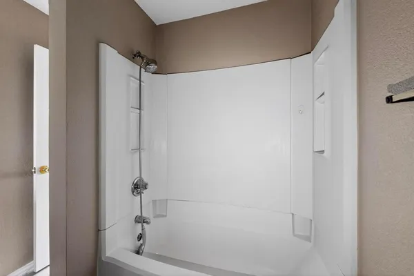 a bathroom with a shower and a tub